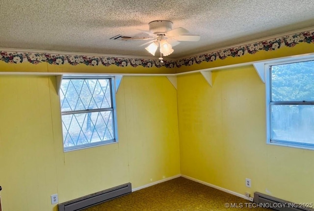 empty room with a textured ceiling, ceiling fan, and baseboard heating