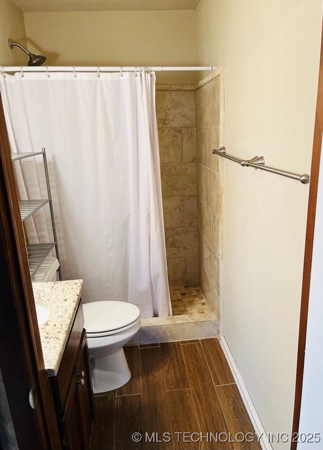 bathroom with vanity, toilet, and walk in shower