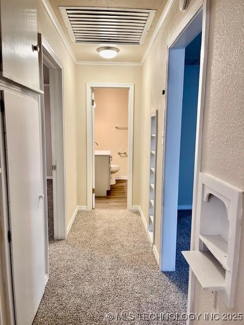 corridor with light carpet and ornamental molding