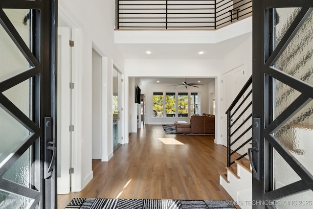 entrance foyer with hardwood / wood-style flooring and a high ceiling