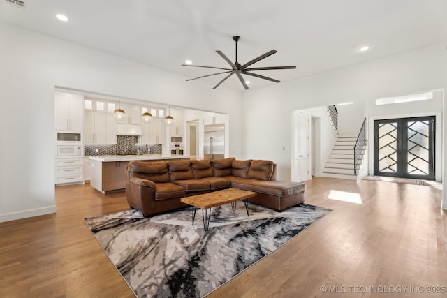 living room with french doors and light hardwood / wood-style floors