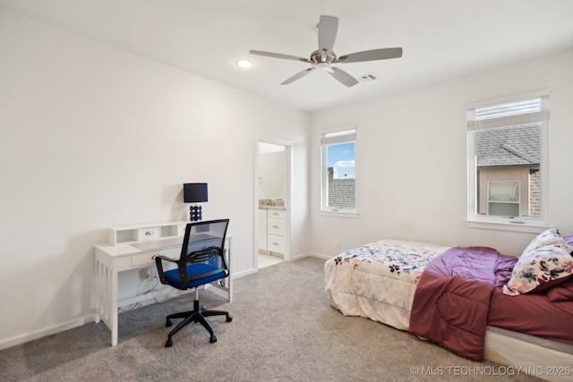 carpeted bedroom featuring ceiling fan and ensuite bath