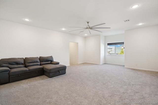 unfurnished living room featuring light colored carpet and ceiling fan