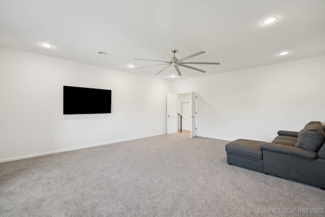 unfurnished living room featuring ceiling fan and carpet floors