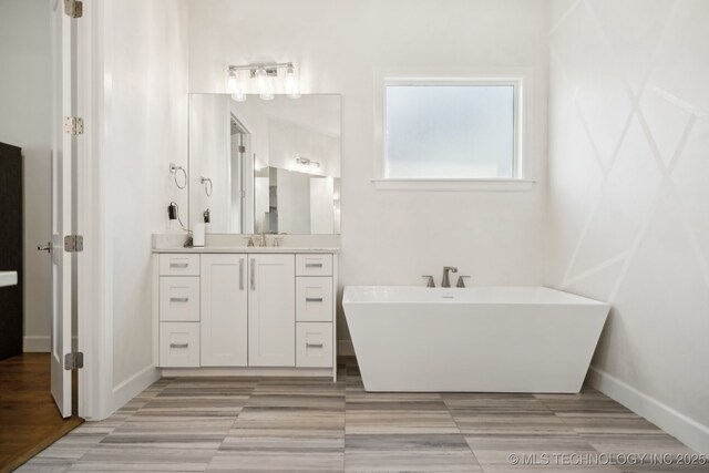 bathroom with vanity and a tub to relax in