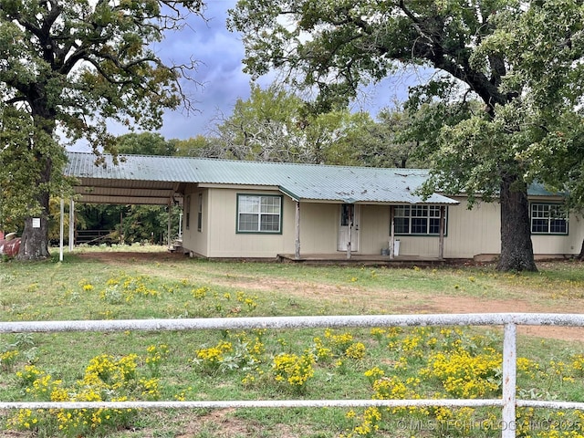 single story home with a front lawn and a carport