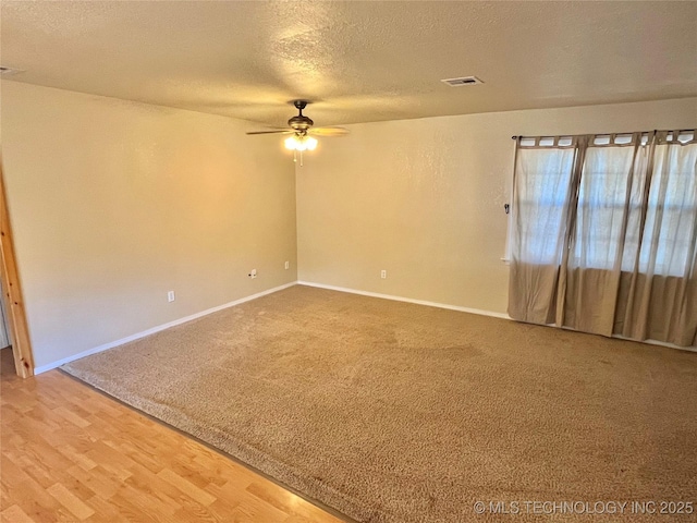 unfurnished room featuring a textured ceiling, hardwood / wood-style flooring, and ceiling fan