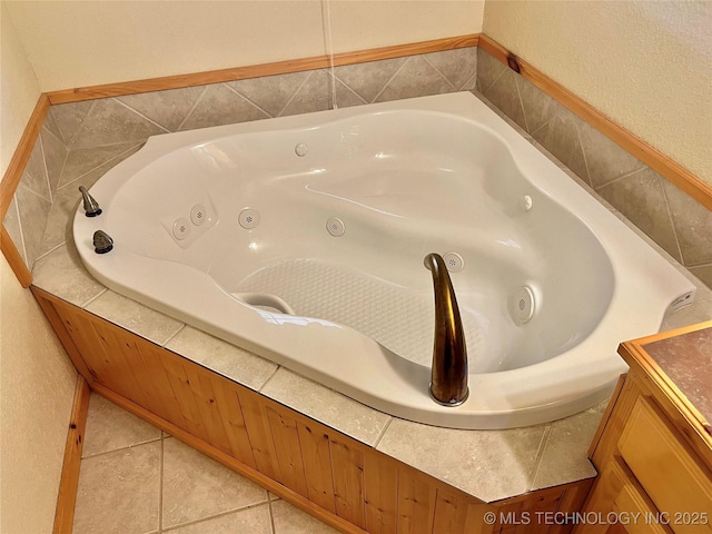 bathroom featuring tile patterned flooring and a washtub