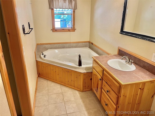 bathroom with tile patterned floors, a bathtub, and vanity