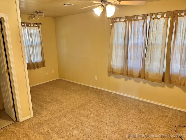 carpeted spare room with ceiling fan