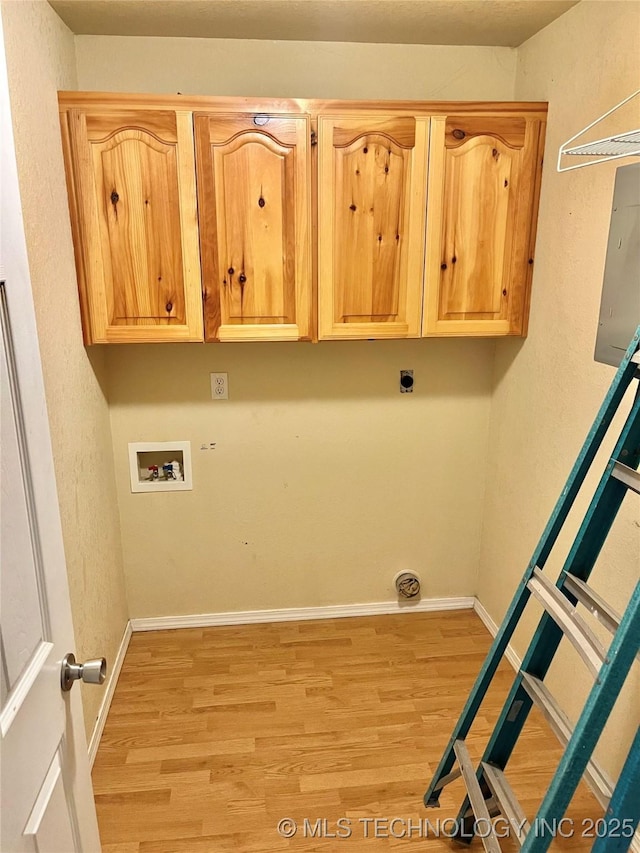 laundry room with washer hookup, hookup for an electric dryer, cabinets, and light wood-type flooring