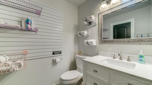 half bath with vanity and toilet