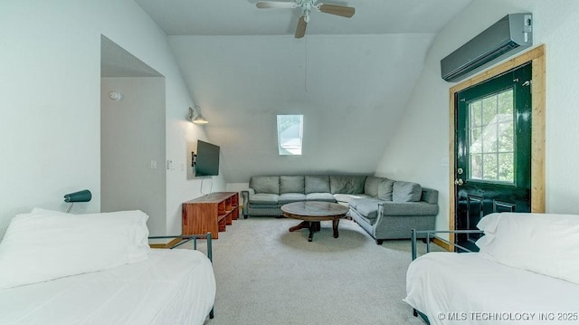 carpeted living area with ceiling fan, a wall unit AC, and lofted ceiling with skylight