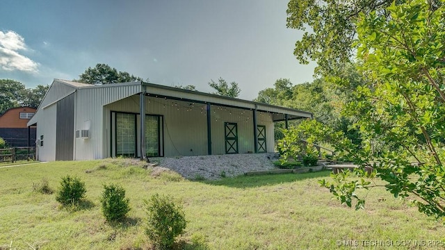 rear view of house featuring a yard