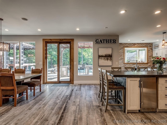 dining space with recessed lighting, baseboards, and dark wood finished floors