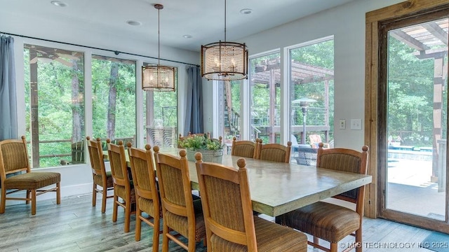 dining area featuring recessed lighting, a chandelier, and light wood-style flooring
