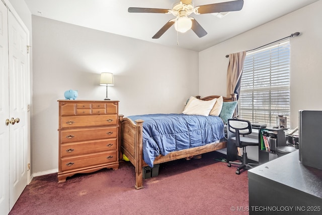 carpeted bedroom with ceiling fan and a closet