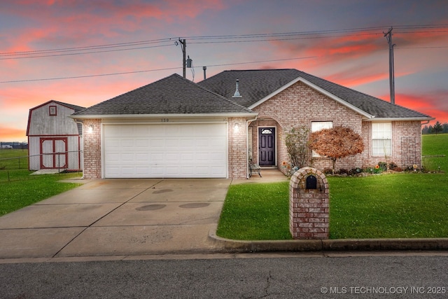 view of front of property with a lawn and a garage