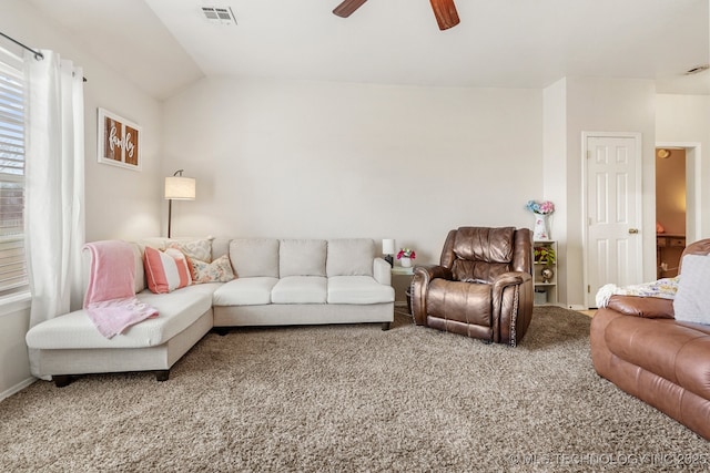 carpeted living room featuring ceiling fan and vaulted ceiling