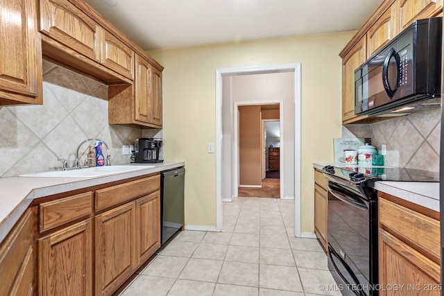 kitchen with black appliances, light tile patterned flooring, sink, and tasteful backsplash