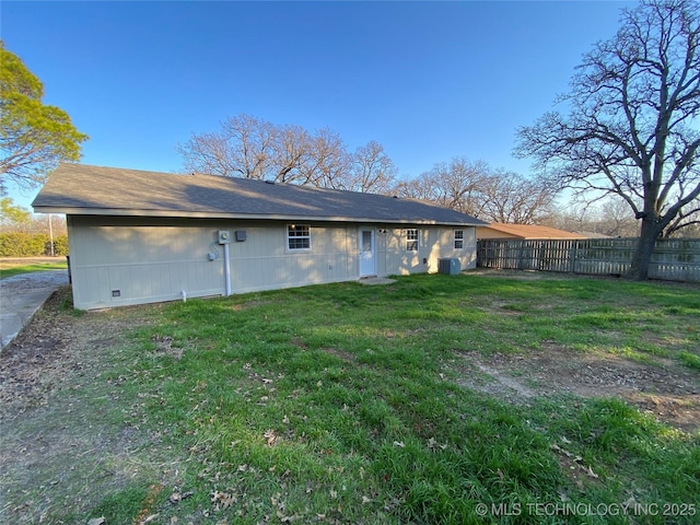 back of property featuring a lawn and cooling unit