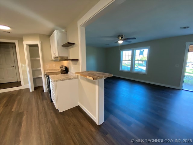 kitchen with ceiling fan, dark wood-type flooring, black range with electric cooktop, kitchen peninsula, and white cabinets