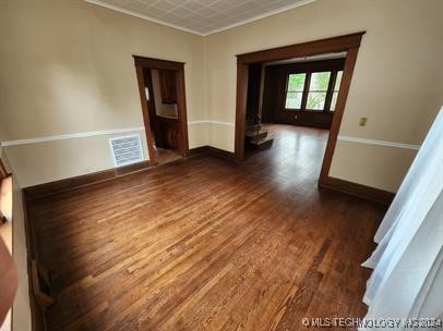 spare room with dark wood-type flooring