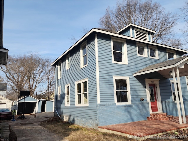 view of front facade featuring a garage and an outdoor structure