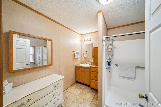 full bath featuring vanity, crown molding, a shower with curtain, and a textured ceiling