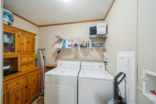 laundry area featuring separate washer and dryer, crown molding, laundry area, and a textured ceiling