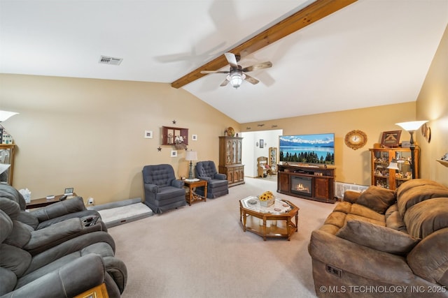 living room featuring visible vents, lofted ceiling with beams, light carpet, a glass covered fireplace, and a ceiling fan