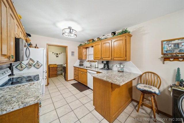 kitchen with stainless steel microwave, dishwasher, electric range oven, light tile patterned floors, and a peninsula