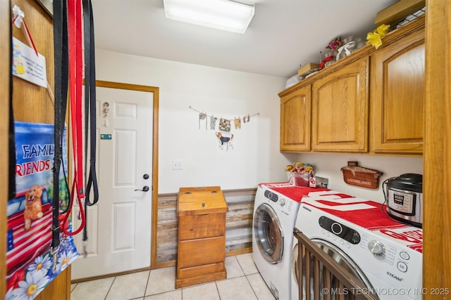 laundry room with light tile patterned floors, cabinet space, and independent washer and dryer