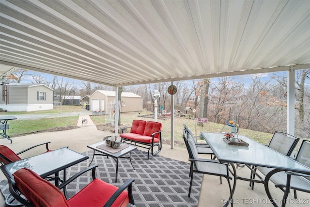 view of patio with outdoor dining area and an outdoor structure