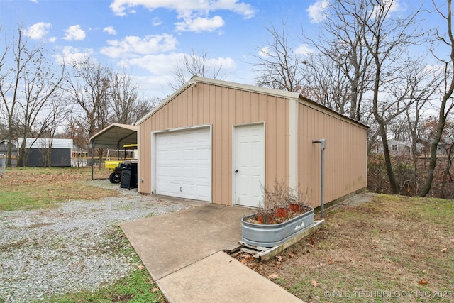 detached garage with a carport and driveway