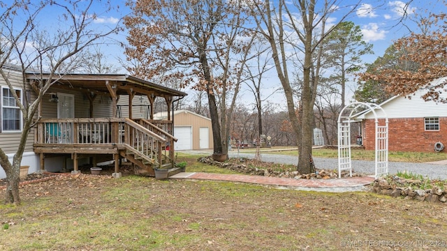 view of yard featuring a porch, a detached garage, and an outdoor structure