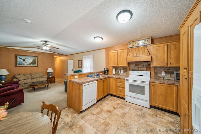 kitchen with open floor plan, custom range hood, a peninsula, white appliances, and a sink