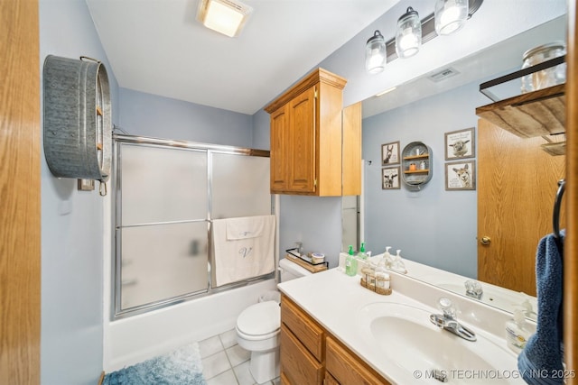 bathroom featuring visible vents, toilet, tile patterned flooring, bath / shower combo with glass door, and vanity