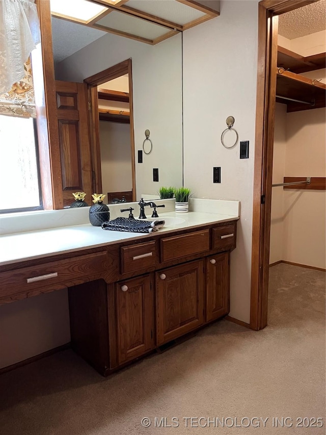 bathroom with vanity and a spacious closet