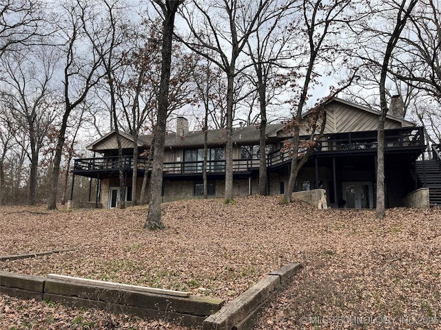 rear view of property featuring a deck