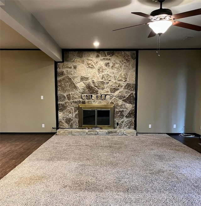 unfurnished living room with a fireplace, carpet, baseboards, and ceiling fan