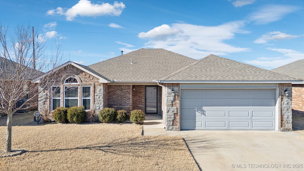 ranch-style home featuring a garage and central AC