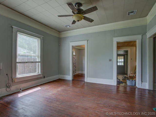 unfurnished room with ceiling fan, plenty of natural light, crown molding, and hardwood / wood-style flooring