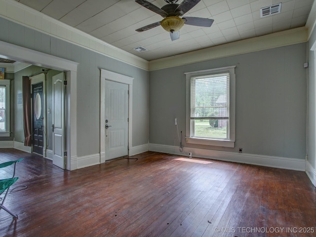 empty room with dark hardwood / wood-style floors, ceiling fan, and crown molding