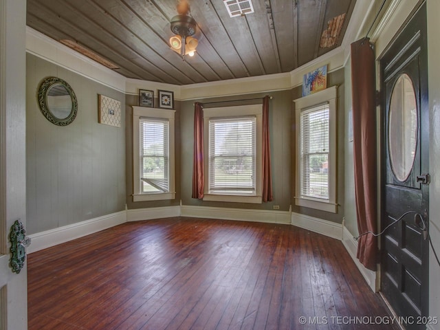 interior space with dark wood-type flooring, wooden ceiling, and ornamental molding