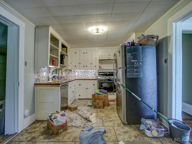 kitchen with tile countertops, white cabinets, sink, decorative backsplash, and appliances with stainless steel finishes