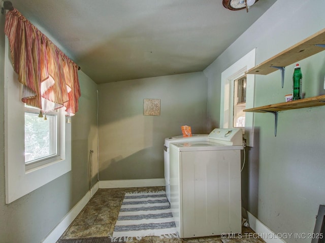 clothes washing area with washing machine and dryer