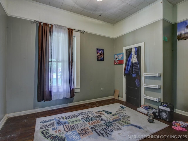 bedroom featuring dark hardwood / wood-style flooring and ornamental molding