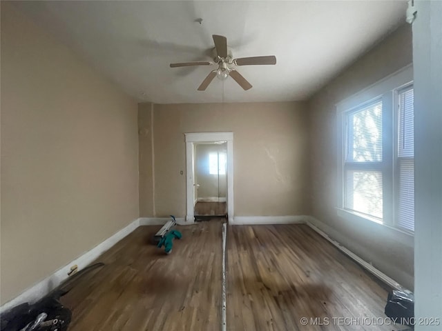 empty room with hardwood / wood-style flooring and ceiling fan