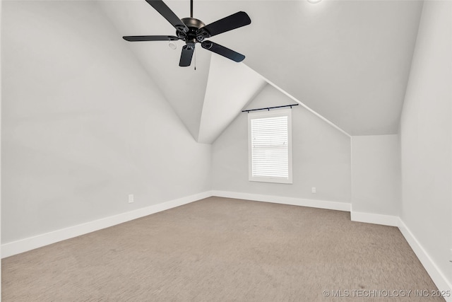 additional living space featuring light carpet, vaulted ceiling, and ceiling fan